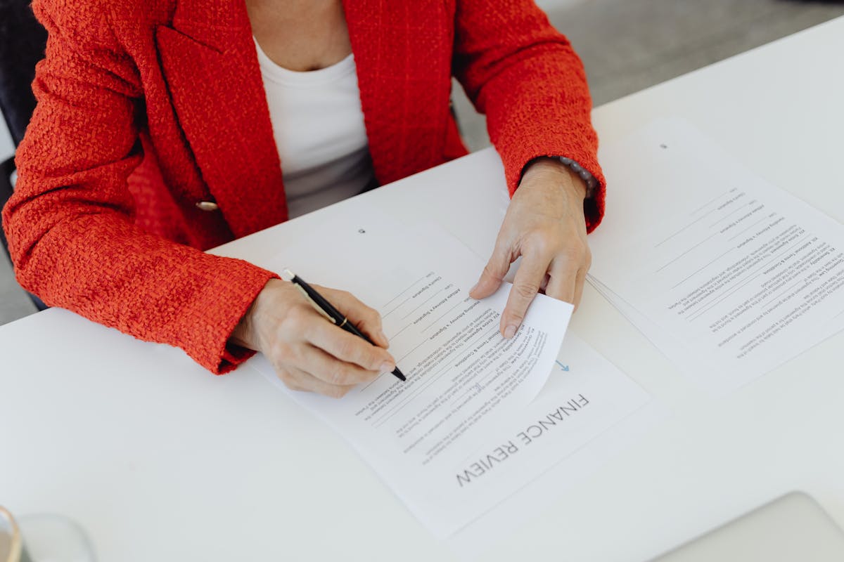 Closing businesswoman signing document