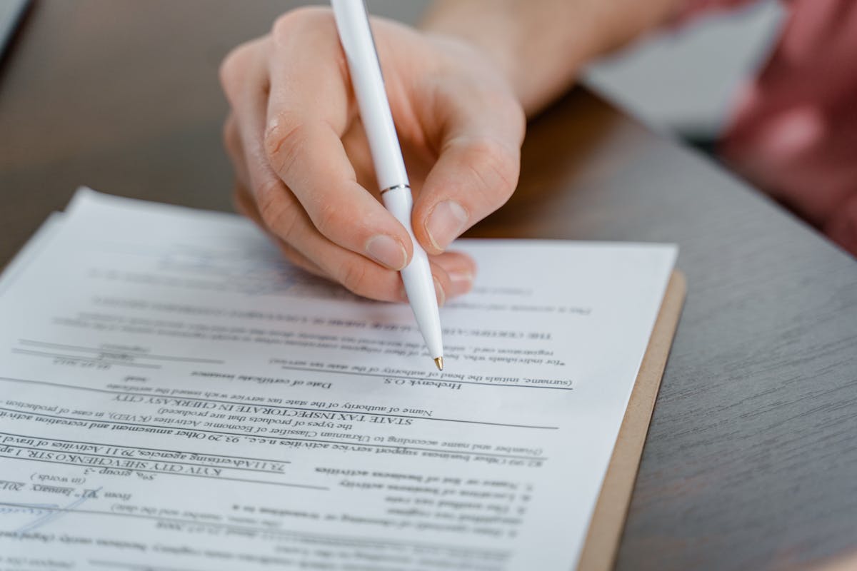 Closing signing agreement pen closeup