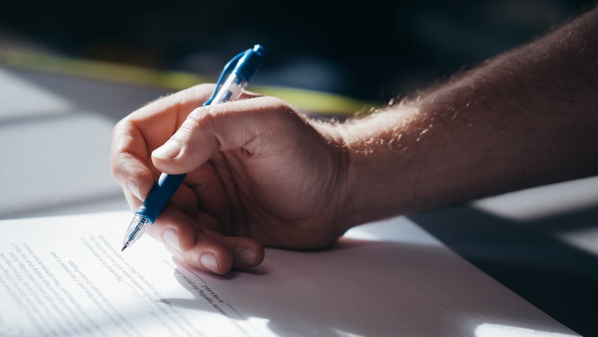 Legal contract signing pen paperwork